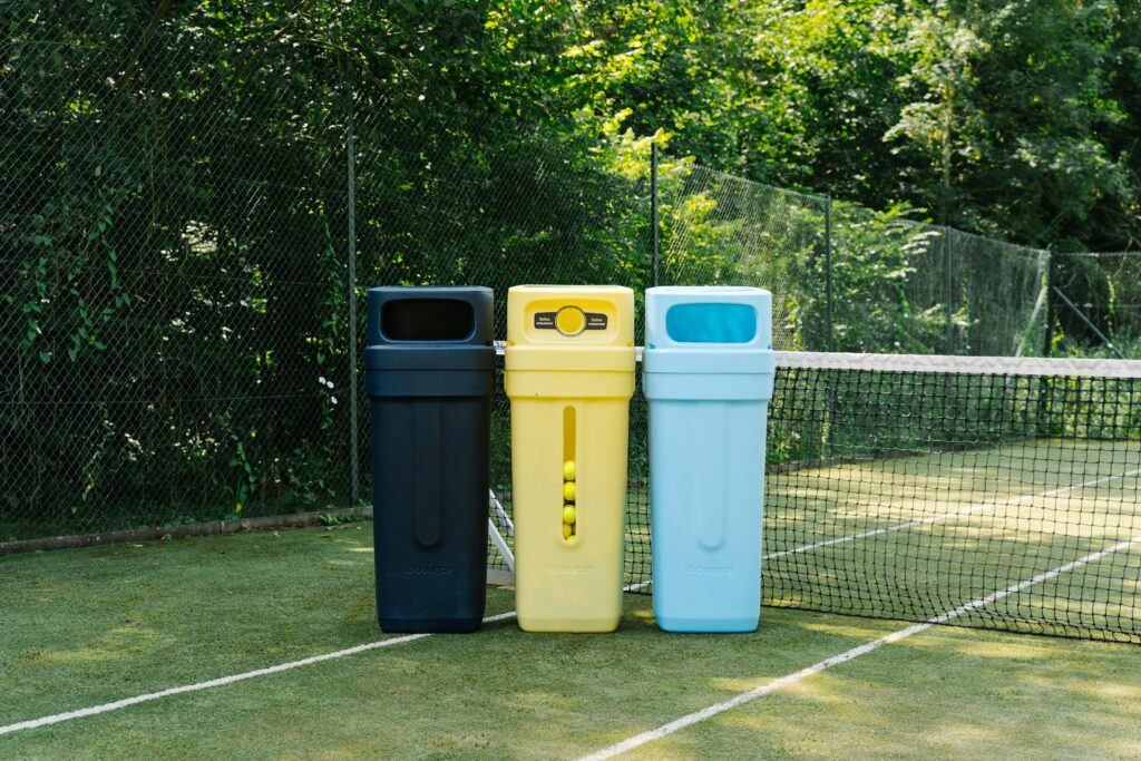 a group of trash cans on a tennis court